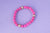 Pulsera piedra volcánica rosa fucsia con bolas doradas