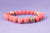 Pulsera piedra volcánica anaranjada con bolas doradas