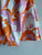 Pantalón estampado retro Naranja y Rosa, elástico, textura suave.